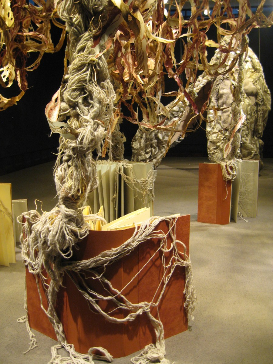 installation detail: books with draped yarn roots