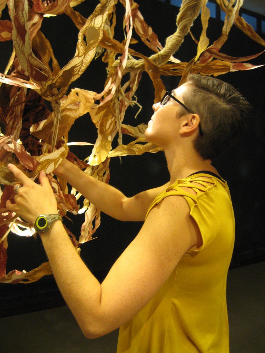 Lena installing printed cut-paper installation