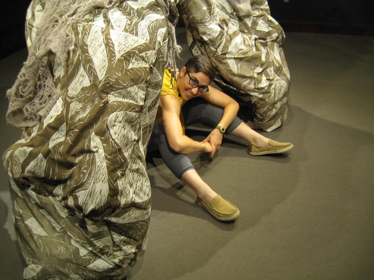 Lena sitting on the floor inside Lung Root sculpture