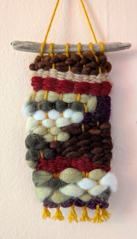 photo of a small weaving in earth tone colors